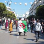 12 March 2019: Two friends wrapped in the Algerian flag march in front of the University of Algiers during student protests, which have taken place every Friday for the past month. (Photographs by Maher Mezhai)