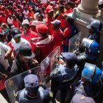 8 October 2018: Abahlali baseMjondolo members face off against the police outside the Durban City Hall. Protestors marched from Curries Fountain to the City Hall in protest against the ongoing killing of its members.