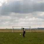 14 April 2019: A player from Cope FC warms up on the thick grass that passes for a football pitch before his team’s game in Baleni in the Eastern Cape’s Mpondoland.