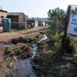 7 May 2019: Rubbish and dirty water stream past a voting station in Kliptown.