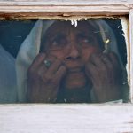 13 September 2019: A Kashmiri woman in Srinagar looks out from a mosque window at a protest about the Indian government scrapping the special constitutional status of Kashmir.