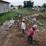 10 December 2019: Children play in rubbish and raw sewage on a street in Old Location, Kowa, in the Eastern Cape.