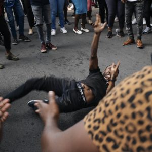 12 March 2021: Students from the Wits Economic Freedom Fighters sing struggle songs and dance near the spot where Mthokozisi Ntumba was shot and killed by police during protests against financial exclusion. (Photograph by James Puttick)